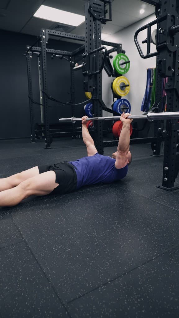 Floor press training under the rack at Iron Focus Gym